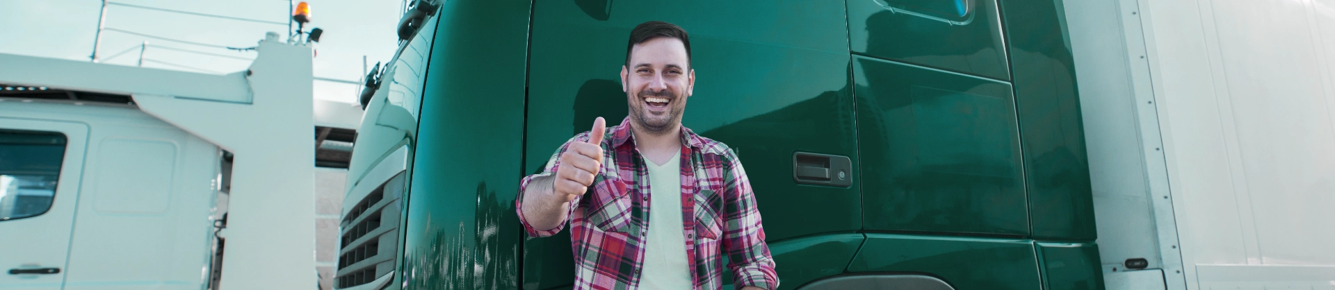 professional-truck-driver-front-long-transportation-vehicle-holding-thumbs-up-ready-new-ride
